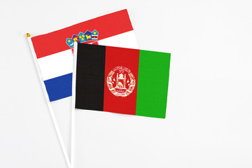 Afghanistan and Croatia stick flags on white background. High quality fabric, miniature national...