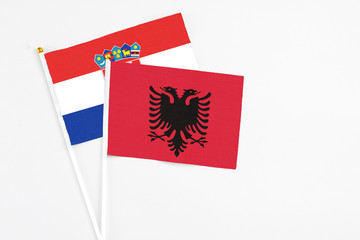 Albania and Croatia stick flags on white background. High quality fabric, miniature national flag. Peaceful global concept.White floor for copy space.