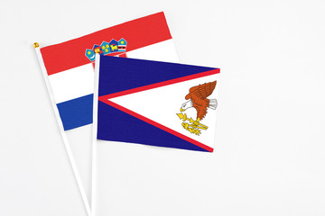 American Samoa and Croatia stick flags on white background. High quality fabric, miniature national flag. Peaceful global concept.White floor for copy space.