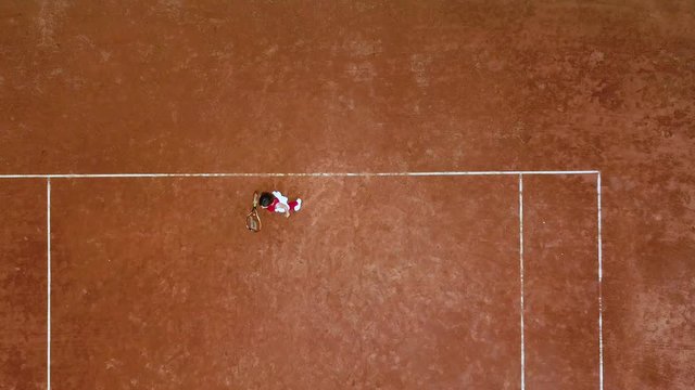 Young tennis player hits a racquet ball on a tennis court