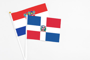 Dominican Republic and Croatia stick flags on white background. High quality fabric, miniature national flag. Peaceful global concept.White floor for copy space.