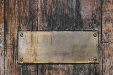brass signage on wooden floor
