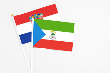 Equatorial Guinea and Croatia stick flags on white background. High quality fabric, miniature national flag. Peaceful global concept.White floor for copy space.