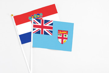 Fototapeta premium Fiji and Croatia stick flags on white background. High quality fabric, miniature national flag. Peaceful global concept.White floor for copy space.