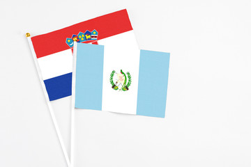 Guatemala and Croatia stick flags on white background. High quality fabric, miniature national flag. Peaceful global concept.White floor for copy space.