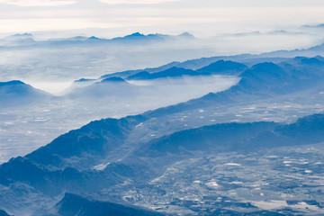 Obraz na płótnie Canvas foggy mountains and clouds from the sky