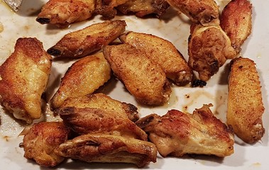 Grilled chicken small marinated wings and look very juicy and mouth-watering