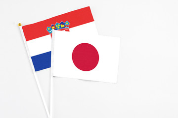 Japan and Croatia stick flags on white background. High quality fabric, miniature national flag. Peaceful global concept.White floor for copy space.