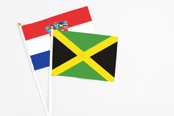 Jamaica and Croatia stick flags on white background. High quality fabric, miniature national flag. Peaceful global concept.White floor for copy space.