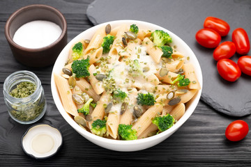 Pasta with white sauce, broccoli and pumpkin seeds