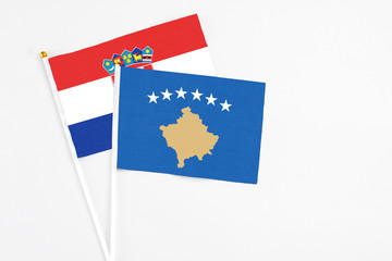 Kosovo and Croatia stick flags on white background. High quality fabric, miniature national flag. Peaceful global concept.White floor for copy space.