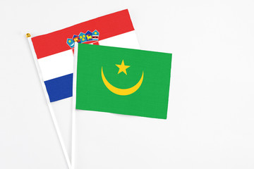 Mauritania and Croatia stick flags on white background. High quality fabric, miniature national flag. Peaceful global concept.White floor for copy space.
