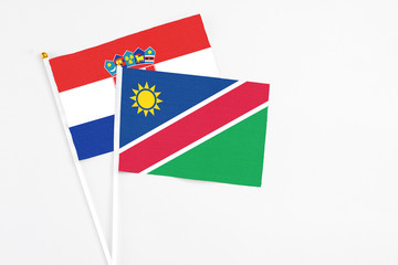 Namibia and Croatia stick flags on white background. High quality fabric, miniature national flag. Peaceful global concept.White floor for copy space.