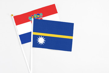 Nauru and Croatia stick flags on white background. High quality fabric, miniature national flag. Peaceful global concept.White floor for copy space.