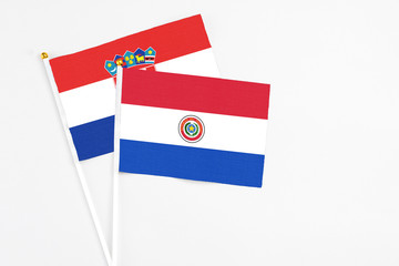 Paraguay and Croatia stick flags on white background. High quality fabric, miniature national flag. Peaceful global concept.White floor for copy space.