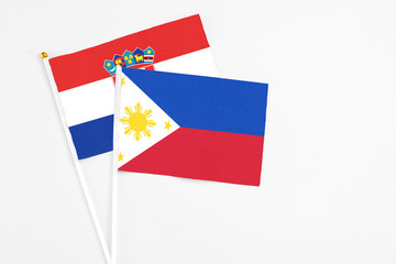 Philippines and Croatia stick flags on white background. High quality fabric, miniature national flag. Peaceful global concept.White floor for copy space.