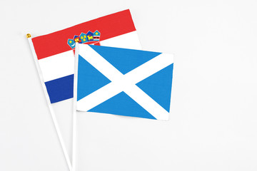 Scotland and Croatia stick flags on white background. High quality fabric, miniature national flag. Peaceful global concept.White floor for copy space.