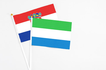 Sierra Leone and Croatia stick flags on white background. High quality fabric, miniature national flag. Peaceful global concept.White floor for copy space.