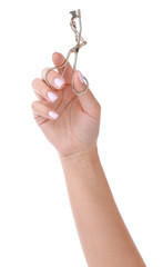 Female hand with eyelash curler on white background