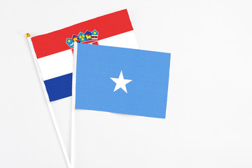 Somalia and Croatia stick flags on white background. High quality fabric, miniature national flag. Peaceful global concept.White floor for copy space.