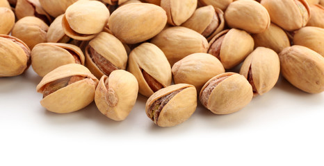 Tasty pistachio nuts isolated on white