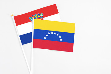 Venezuela and Croatia stick flags on white background. High quality fabric, miniature national flag. Peaceful global concept.White floor for copy space.