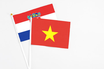 Vietnam and Croatia stick flags on white background. High quality fabric, miniature national flag. Peaceful global concept.White floor for copy space.