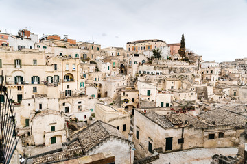 Fototapeta na wymiar Long panoramic views of the rocky old town of Matera with its stone roofs.