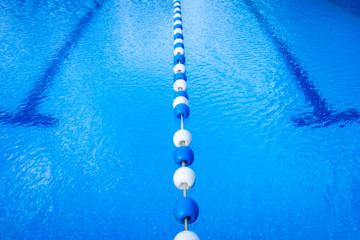 Detail of the water of a pool with beacons to separate the swimming streets.