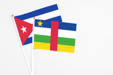 Central African Republic and Cuba stick flags on white background. High quality fabric, miniature national flag. Peaceful global concept.White floor for copy space.