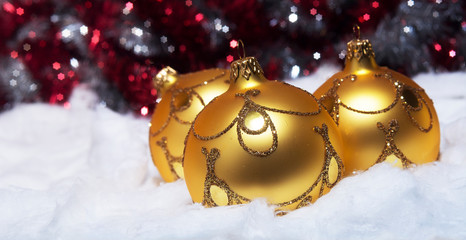 Beautiful golden baubles in a festive winter climate.