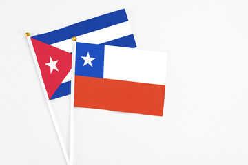 Chile and Cuba stick flags on white background. High quality fabric, miniature national flag. Peaceful global concept.White floor for copy space.