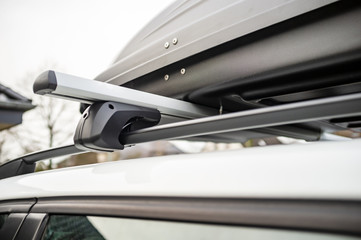 Closed assembled trunk or cargo box on the roof of the car, before a family vacation.