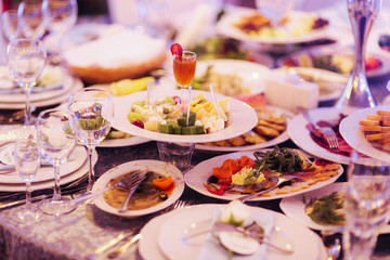 Table with mixed food. Banquet in restaurant, table setting. Differend meals for the guests. Fresh food