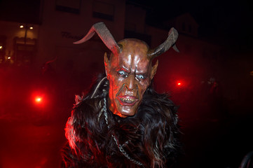 Unidentified person wearing a scary mask on a traditional parade named Krampuslauf in Austria...