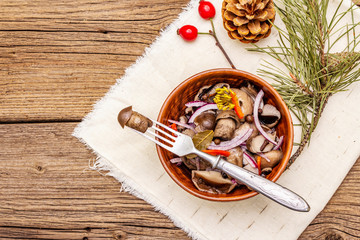 Pickled (fermented) mushrooms. Traditional New Year (Christmas) snack. Festive table cutlery setting