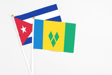 Saint Vincent And The Grenadines and Cuba stick flags on white background. High quality fabric,...