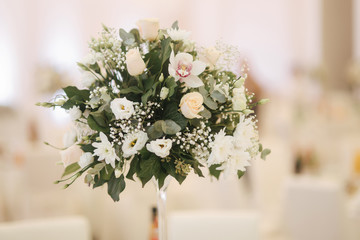 Flowers on the wedding table in restaurant