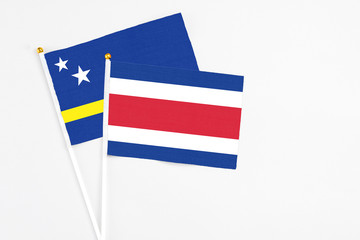 Costa Rica and Curacao stick flags on white background. High quality fabric, miniature national flag. Peaceful global concept.White floor for copy space.