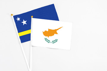 Cyprus and Curacao stick flags on white background. High quality fabric, miniature national flag. Peaceful global concept.White floor for copy space.