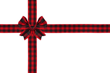 Red and black buffalo plaid Christmas gift bow and ribbon arranged as wrapped gift box isolated on...