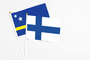 Finland and Curacao stick flags on white background. High quality fabric, miniature national flag....