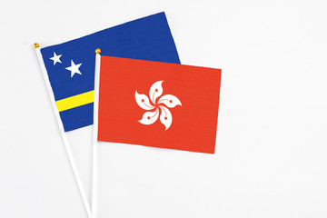 Hong Kong and Curacao stick flags on white background. High quality fabric, miniature national flag. Peaceful global concept.White floor for copy space.