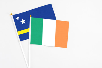Ireland and Curacao stick flags on white background. High quality fabric, miniature national flag. Peaceful global concept.White floor for copy space.