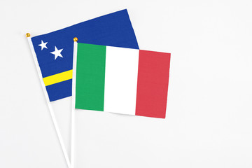 Italy and Curacao stick flags on white background. High quality fabric, miniature national flag. Peaceful global concept.White floor for copy space.
