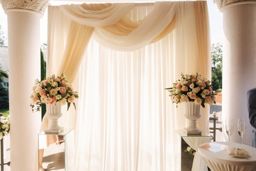 Arch decorated with flowers at the wedding caremony. White and pink color. Rose