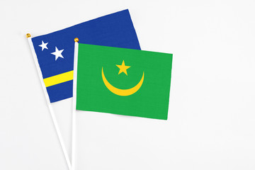 Mauritania and Curacao stick flags on white background. High quality fabric, miniature national flag. Peaceful global concept.White floor for copy space.