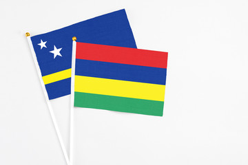 Mauritius and Curacao stick flags on white background. High quality fabric, miniature national flag. Peaceful global concept.White floor for copy space.