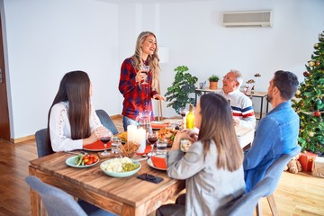 Beautiful family meeting smiling happy and confident. Speaking speech eating roasted turkey celebrating Christmas at home
