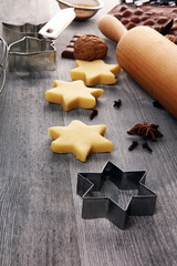 Baking christmas cookies. Typical cinnamon stars bakery with spices. xmas decoration on table